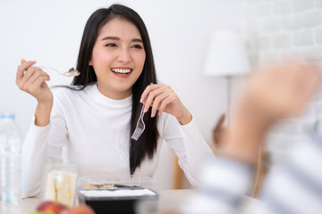Beauty Young Asian woman eating lunchbox set with friend.