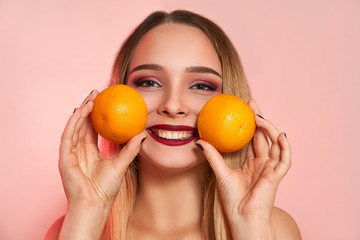 Beautiful girl with orange, isolated on studio background. Cosmetics, food, beauty fashion concept, space for text