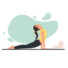 Young beautiful flexible girl doing yoga at home with pet. 