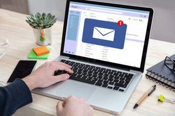 Email message inbox notification on laptop screen, business background