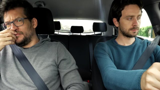 Two men sitting in car driving worried about future financial problems after coronavirus quarantine