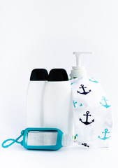Disinfection product in white bottle standing next to Aloe Vera hand gel and handmade face mask, isolated on white background. Hand skincare and protection during corona virus outbreak.