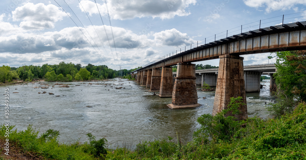 Wall mural a railroad bridge made from stone and metal crossing the broad river in columbia, south carolina tak