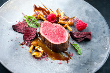 Barbecue dry aged wagyu beef fillet head medallion steak natural with forest fruits, mushrooms and...