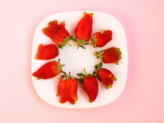 Ugly food: unusual strawberries in a plate