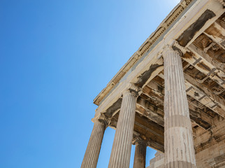 Fototapeta premium Athens, Greece. Erechtheion Temple of Athena on Acropolis hill, blue sky background