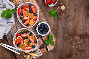 Sweet tiny pancake cereals with berries