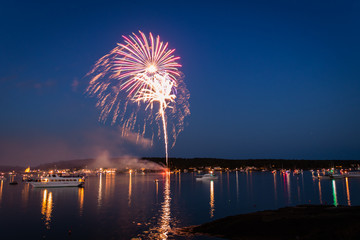 Boats in the harbor during fireworks display, slow shutter, motion blur
