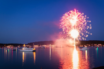Boats in the harbor during fireworks display, slow shutter, motion blur
