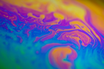 iridescent rainbow on the surface of a soap bubble sphere. Colorful background insane colors psychedelic