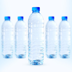 Picture of a water bottle with a full bottle of water Behind there are many blurred bottles. Carrying a white background. Embedded with path For easy editing.