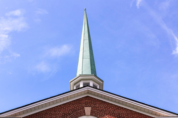 Closeup of the Baptist church steeple against the blue sky