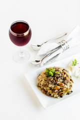 Traditional Turkish Islamic Feast table designed with braised meat and rice near yogurt on the white surface with cold cherry juice and red roses.