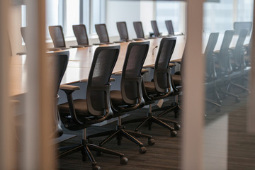 Office chairs at table seen through doorway at office