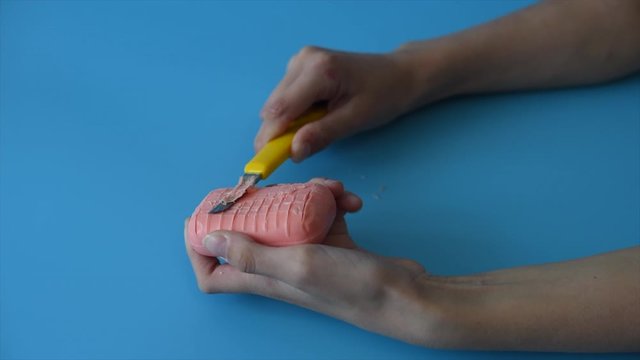 girl hands cuts the soap into small pieces