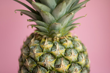 Beautiful tasty fresh pineapple on a delicate pink background
