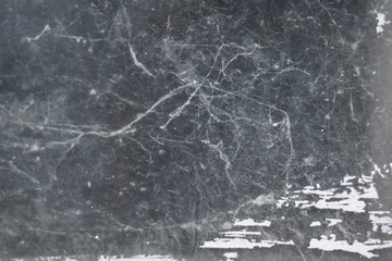 Old gray scary spider web on black window against dark background