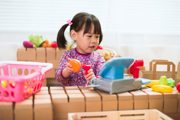 toddler girl pretend play sweet shop keeper at home
