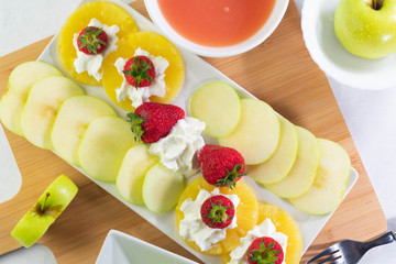 fruit with cream on the table and white light