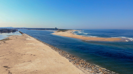 The two sides of Restinga de Ofir. One facing the ocean, the other the estuary of Cávado River. The jetty structure that protects the coastline from the currents and tides in Esposende, Portugal.