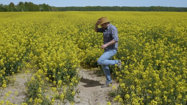 Happy Man Farmer Dancing Enjoying at Rape Blossom On Field. Fun Celebrating Funny Viral Dance Freedom. Guy Enjoying Dance. Joyful Man Farmer Dancing. Flowering Rapeseed Field Blue Sky.
