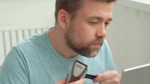 Man makes haircut of beard razor. beauty salons are closed because of pandemic