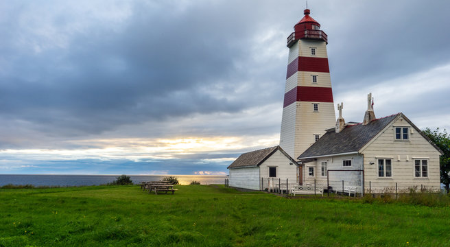 Alnes lighthouse in Godoy, Aalesund, Norway during sunset and blue hour.