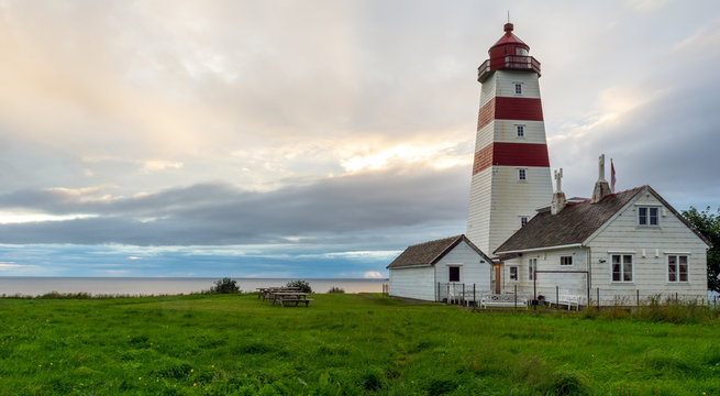 Alnes lighthouse in Godoy, Aalesund, Norway during sunset and blue hour.