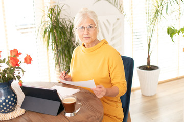 Senior woman working at home.