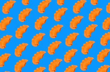 Raw pasta diagonally arranged on a blue background