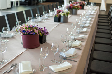 a long table served with dishes and flowers. horizontal frame