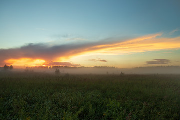 Landscape On Meadow With Fog Under Cloud With Sunset In Evening.