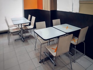 table and chairsRestaurants in Thailand have measures to prevent the spread of COVID 19 virus by allowing to sit and eat only one table per person by putting a mark on the table for customers to see