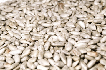 Abstract food background, fried salted peeled sunflower seeds