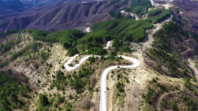 Car driving on zigzag road on Vikos Gorge, Greece
