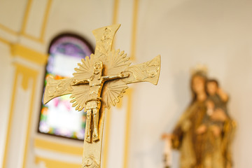 Detail of a golden cross inside a luminous church