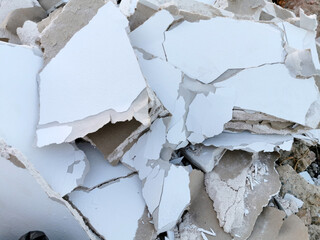 Demolished white brocken plasterboard wall, construction and repair