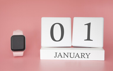 Modern Watch with cube calendar and date 01 january on pink background. Concept winter time vacation.