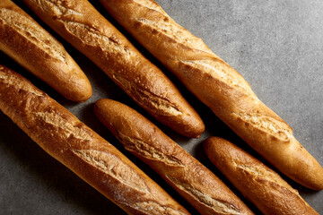 
Freshly baked baguettes on a gray surface. Top view.