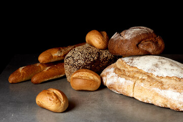 
Assortment of fresh pastries on a gray surface. Black background.
