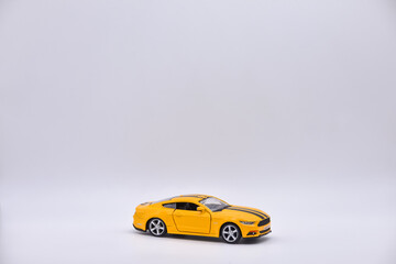Fototapeta na wymiar yellow toy car on white background