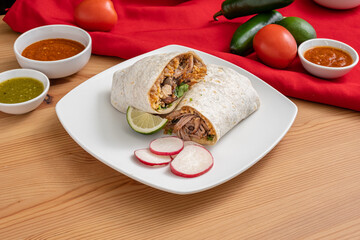 Spicy chicken burrito stuffed with rice and refried beans. Authentic Mexican food with vibrant colors and flavors.