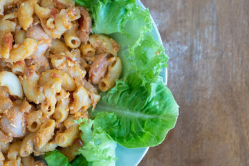 Homemade macaroni pasta with tomato sauce, sausage and vegetables.
