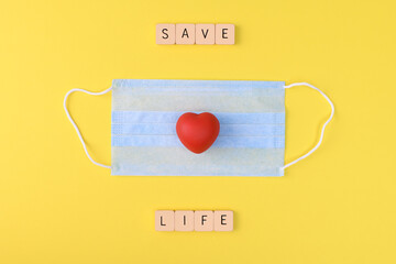 surgical mask and letter blocks with red rubber heart 
