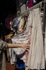 Fototapeta na wymiar Browsing clothes for sale on a market stall