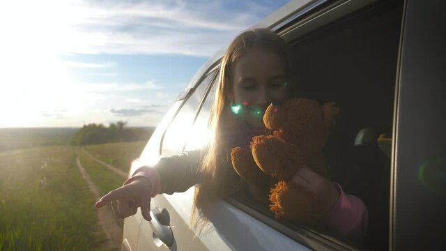 Little girl with teddy bear on road trip full of wonder and exploration. Lifestyle, family travel concept.