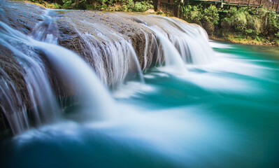 Fototapeta na wymiar Waterfall in Xiaoqikong Scenic Area, Libo County, Southeast Guizhou, China