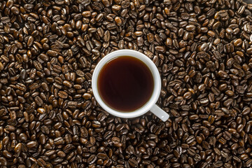 coffee cup and coffee beans on wooden table