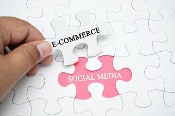 Missing puzzle with a word E-commerce and social media. Business concept puzzle piece. Business and finance concept.