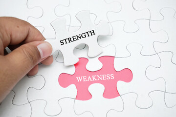Missing puzzle with a word STRENGTH WEAKNESS. Business concept puzzle piece. Business and finance...